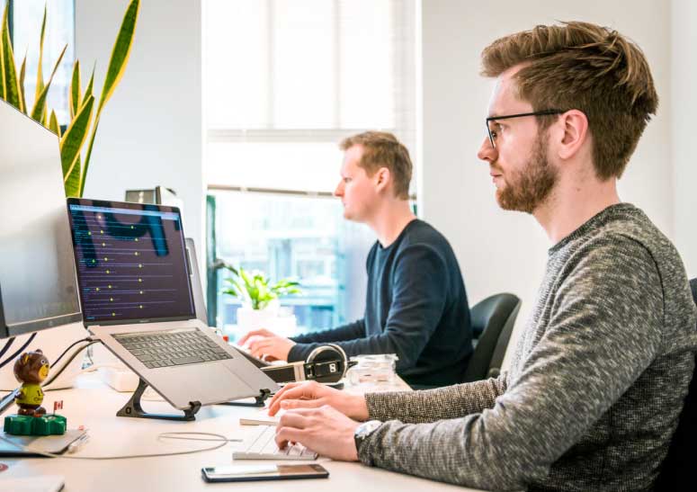 men working on their laptops from office